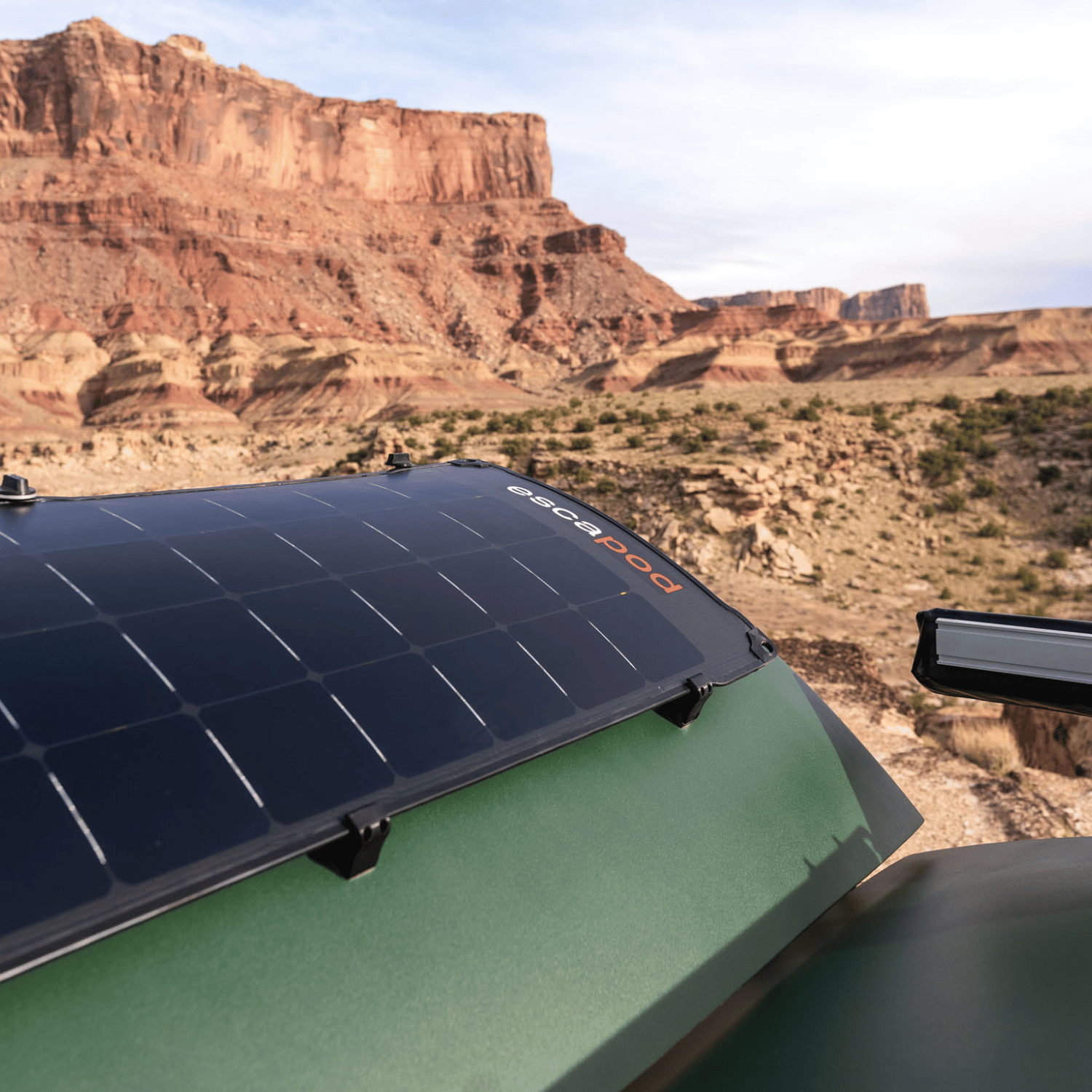 A solar panel on the back of a teardrop camper in full display, soaking up all the sun.