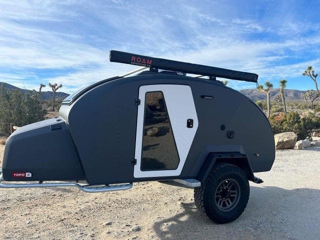 Storm Grey TOPO2 with Powder doors parked in a desert location.