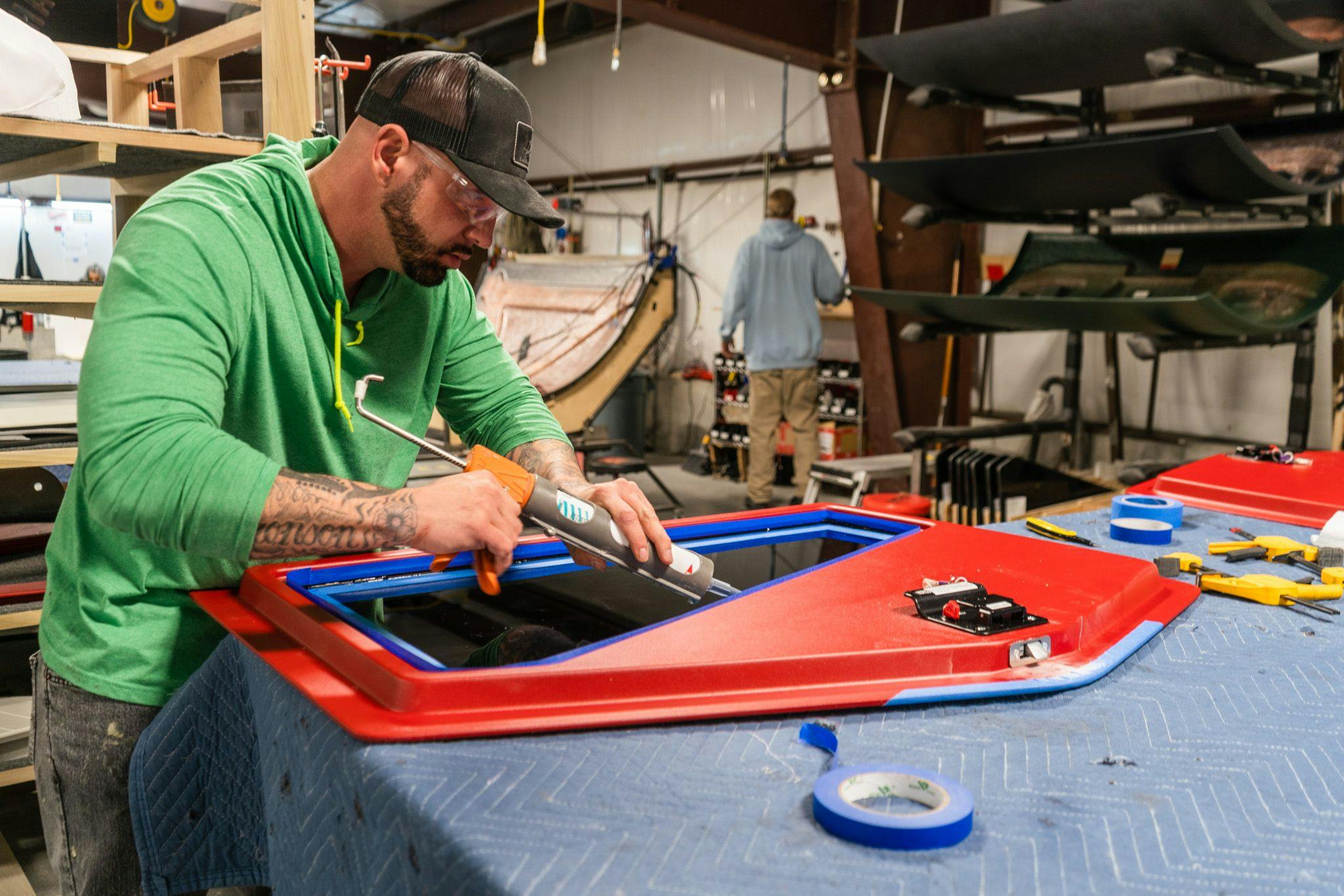 An Escapod employee works on sealing the window to the a TOPO2 fire door.