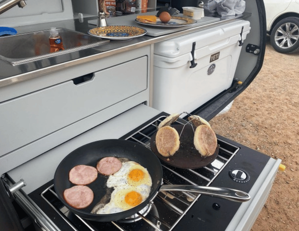 A breakfast meal being cooked in the galley of a TOPO2 an offroad adventure trailer.