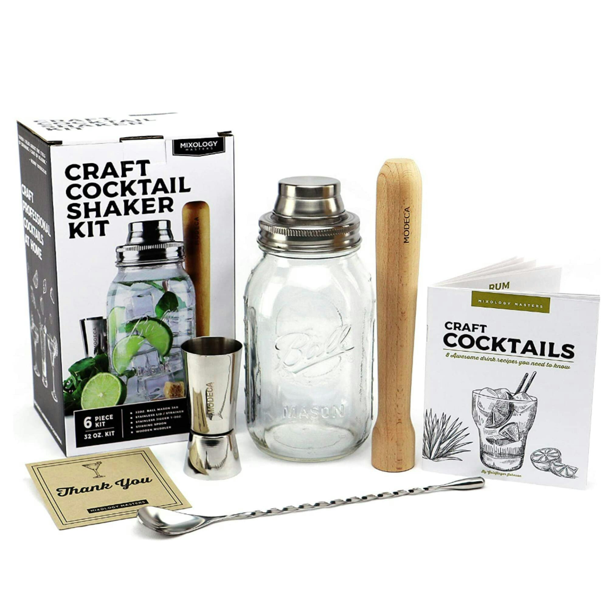 A glass mason jar, wooden muddler, stainless steel shot glass, stirer, and cocktail recipe book are staged on a white background.