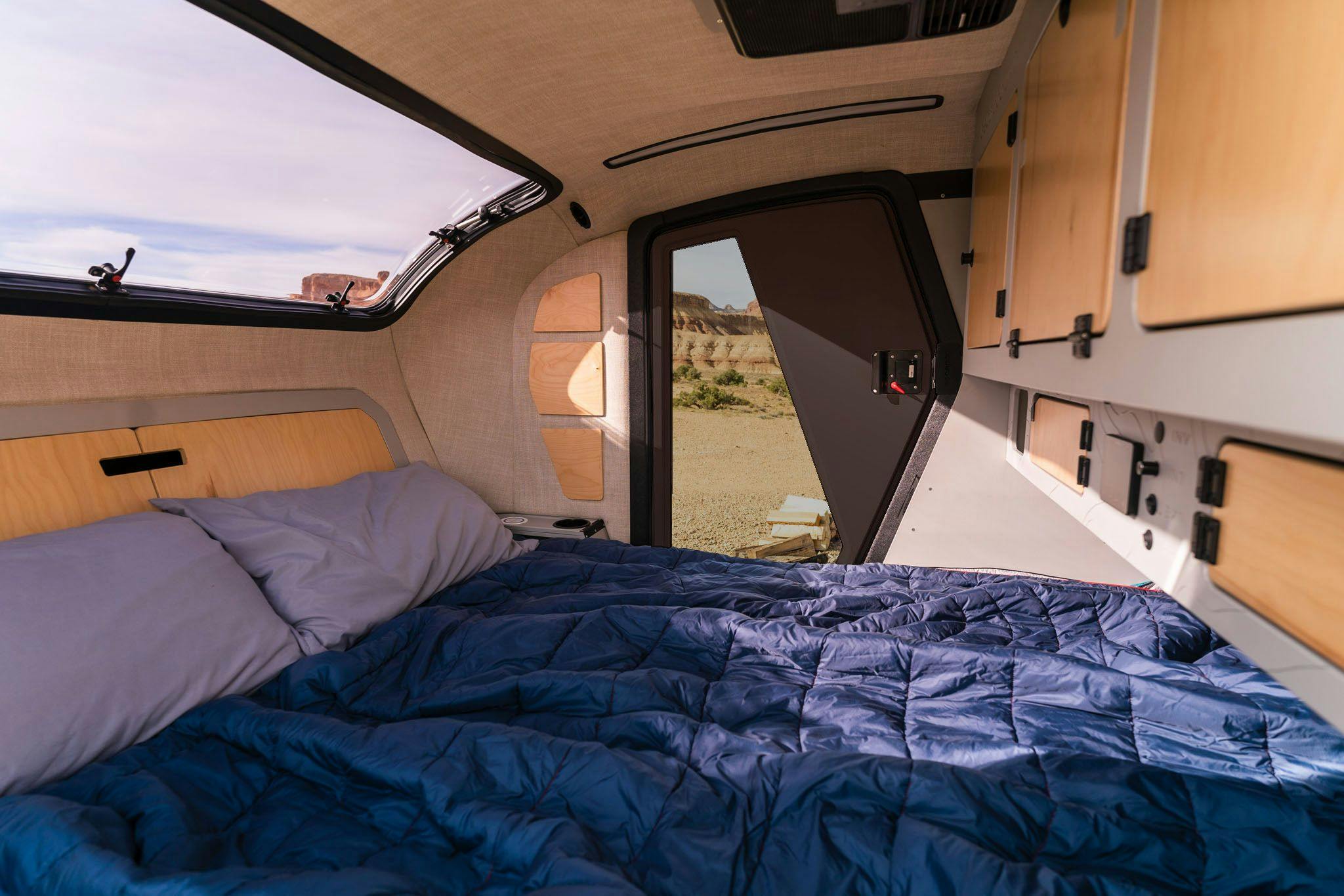 The cabin of a TOPO2 trailer, a teardrop trailer by Escapod Trailers, with a Obsidian door.
