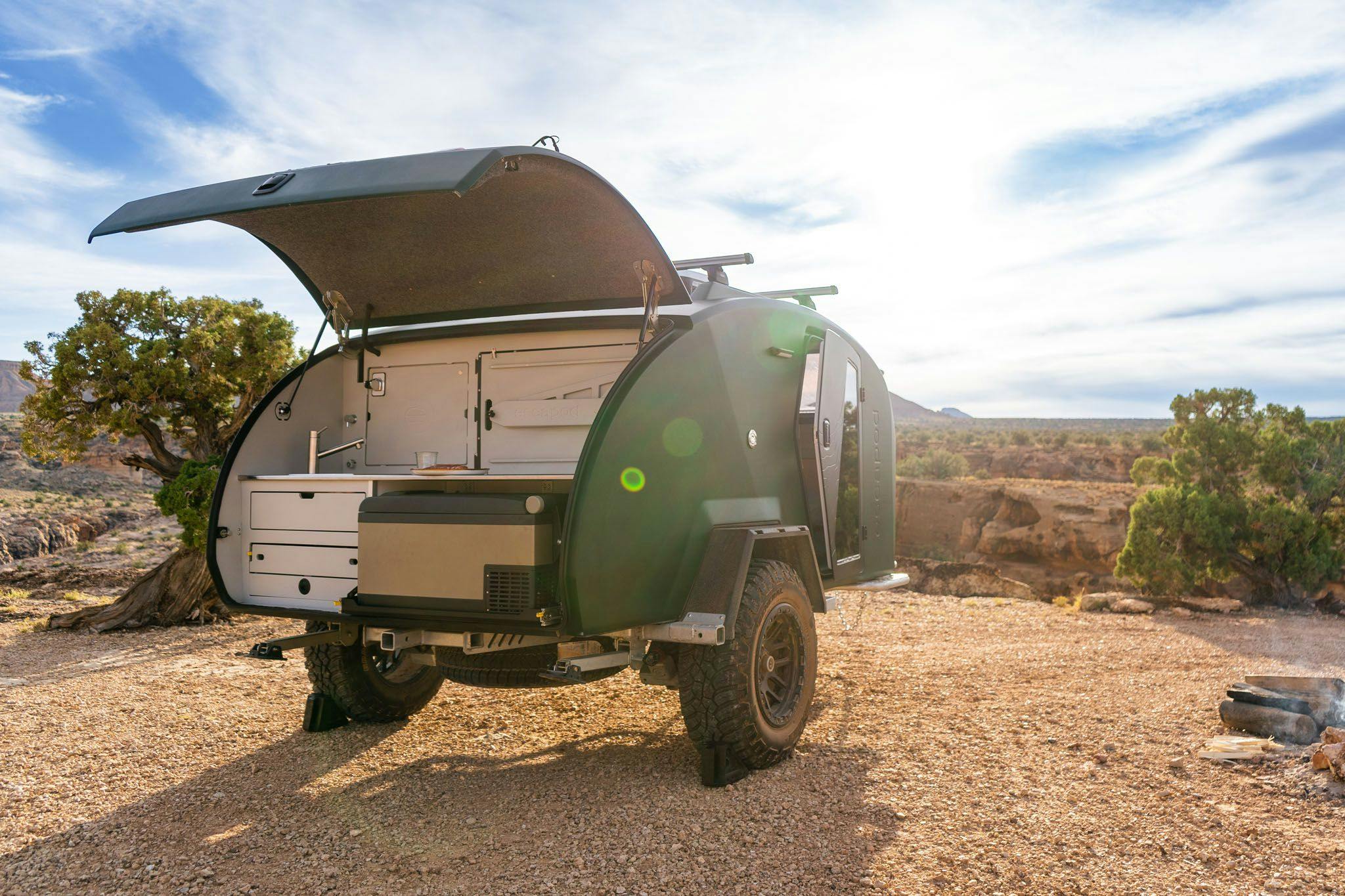 TOPO2, a premium teardrop camper parked with the camp kitchen exposed and ready to cook.