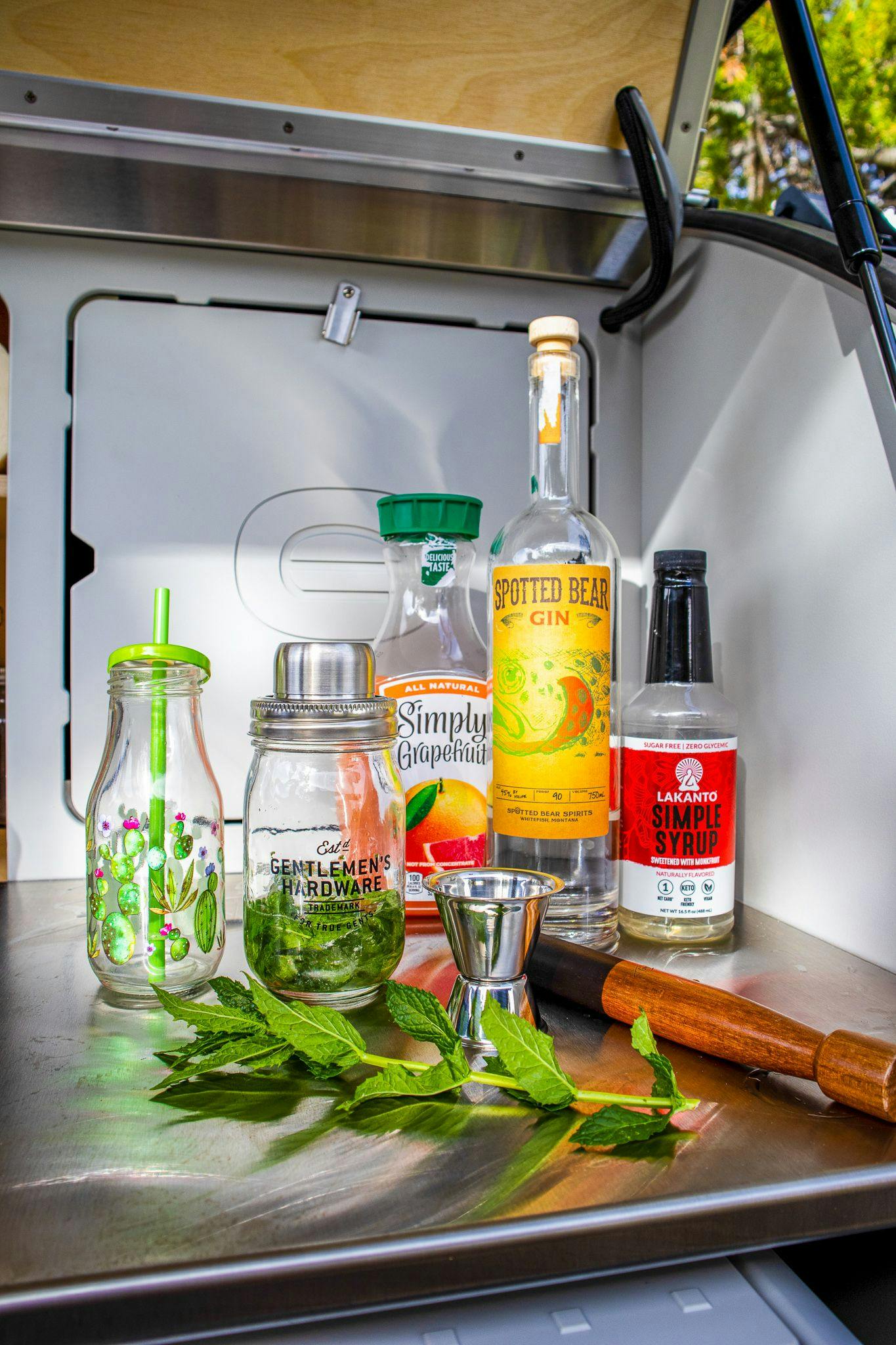 The ingredients required to make a ruby gin cocktail in the back of a teardrop camper!
