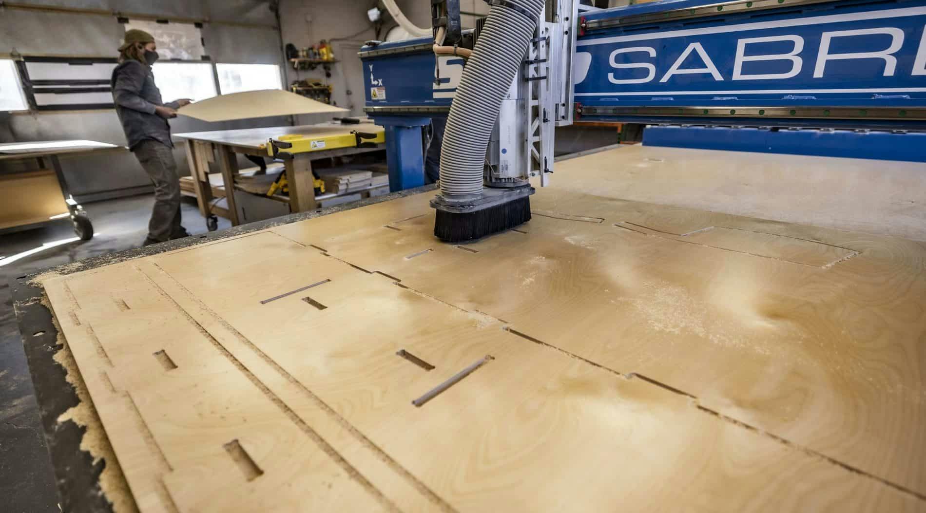 CNC Machine cutting birch cabinet structures to be used to build teardrop trailers.