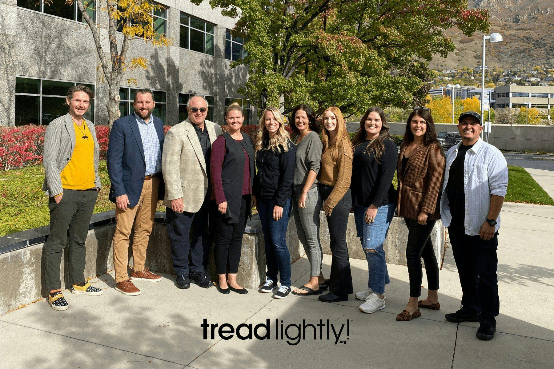 The treadlightly! team standing in a row in front of a building.