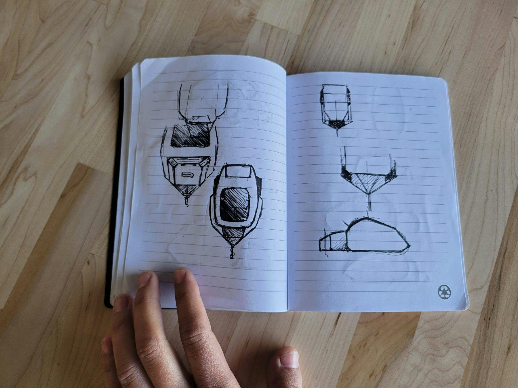 A notebook showing the initial sketches of the TOPO2, an adventure trailer.
