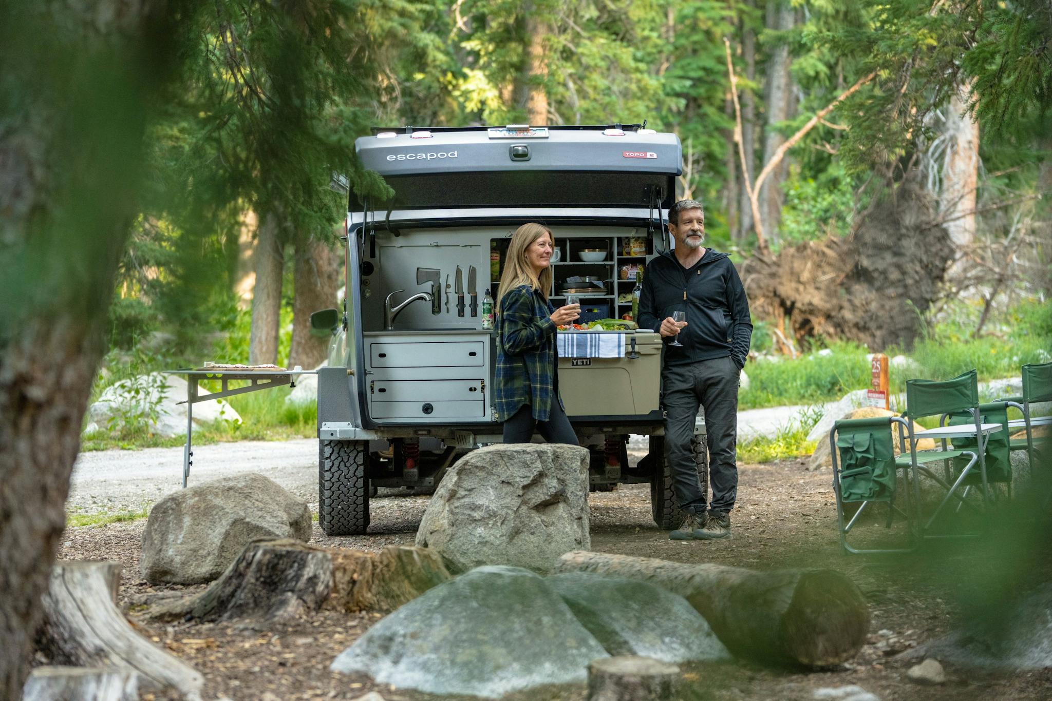 A couple enjoying their time in nature with their TOPO2, a teardrop trailer.