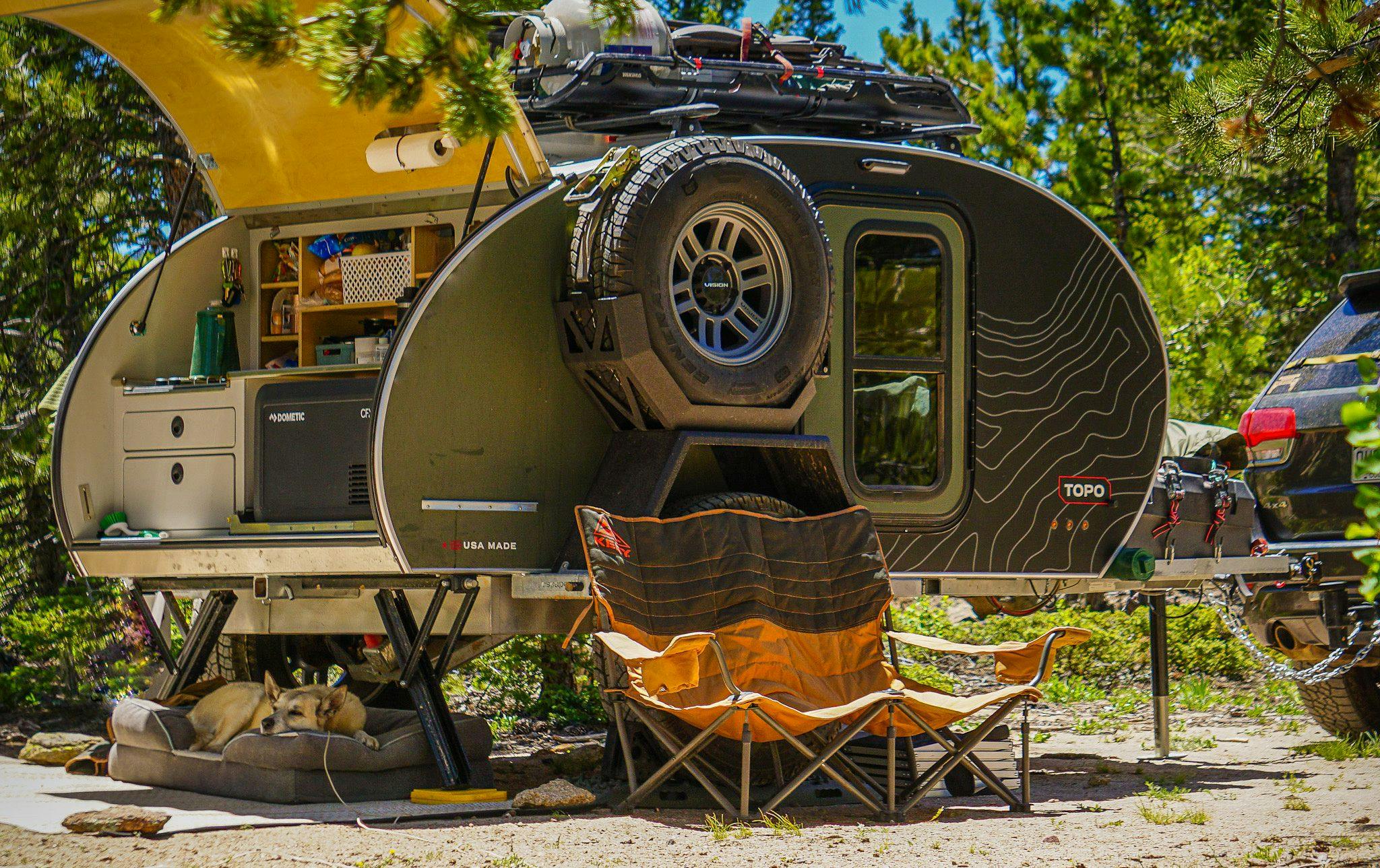 A picture of an Original TOPO, an offroad trailer set up at camp.