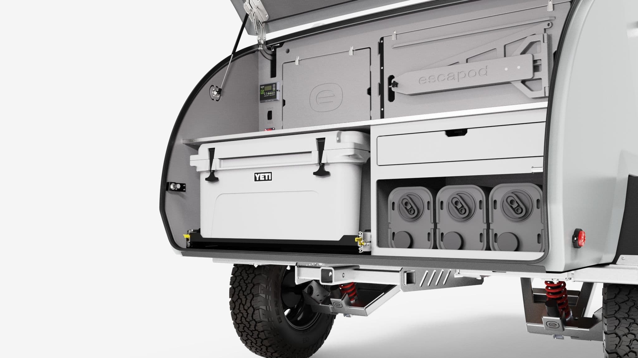 A rendering of the TOPO2 Nomad, featuring the camp kitchen with jerry cans, YETI cooler, cutting board, and table.